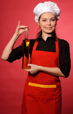 Elidia-female-chef-holding-a-bottle-of-olive-oil